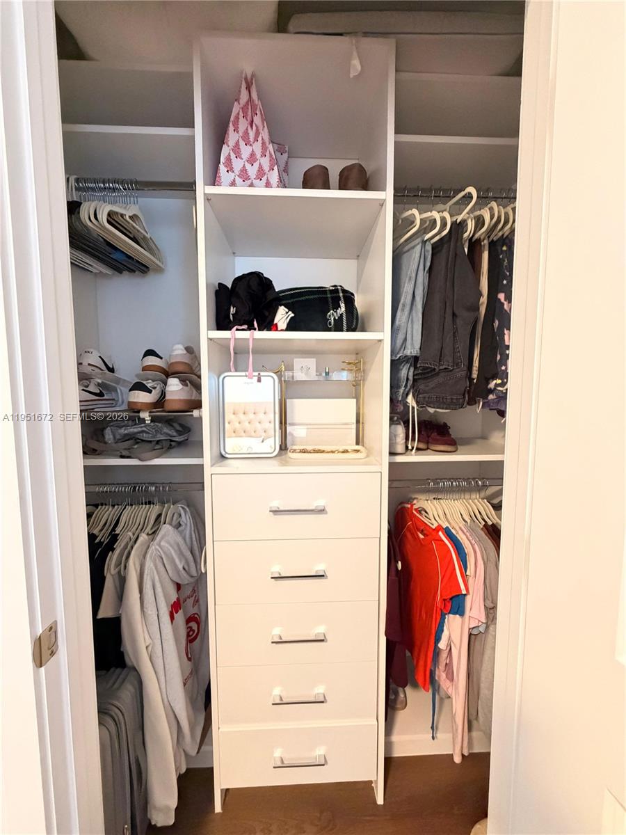7126 Rockwood Road Jupiter, FL 33458 - Photo 27 of 35 a view of walk in closet with clothes and shoes