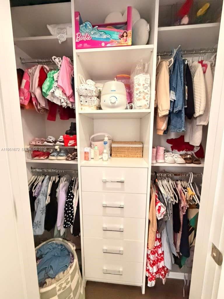 7126 Rockwood Road Jupiter, FL 33458 - Photo 29 of 35 a utility room with lots of different colored cloths