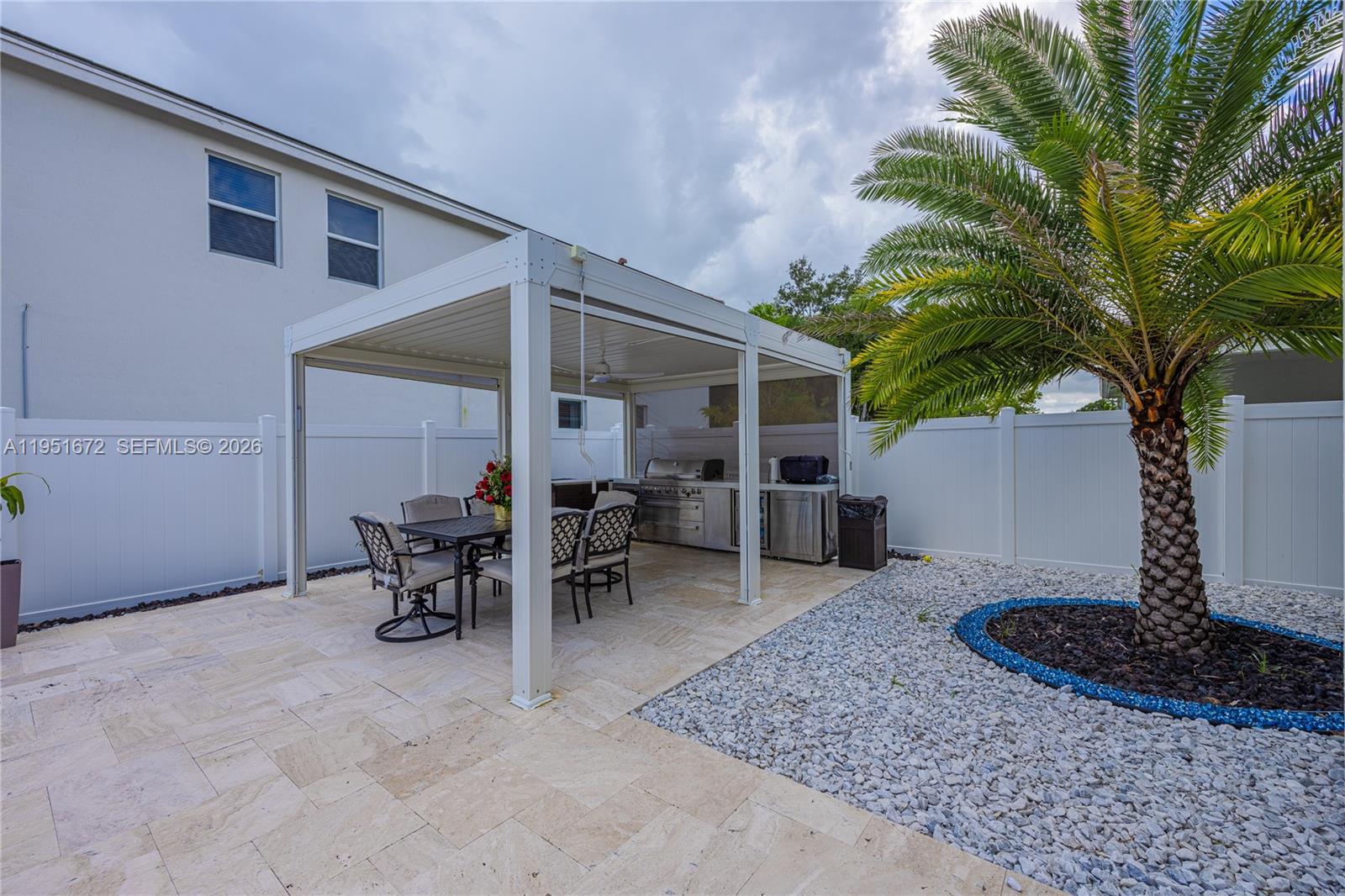 7126 Rockwood Road Jupiter, FL 33458 - Photo 3 of 35 a view of a backyard with table and chairs