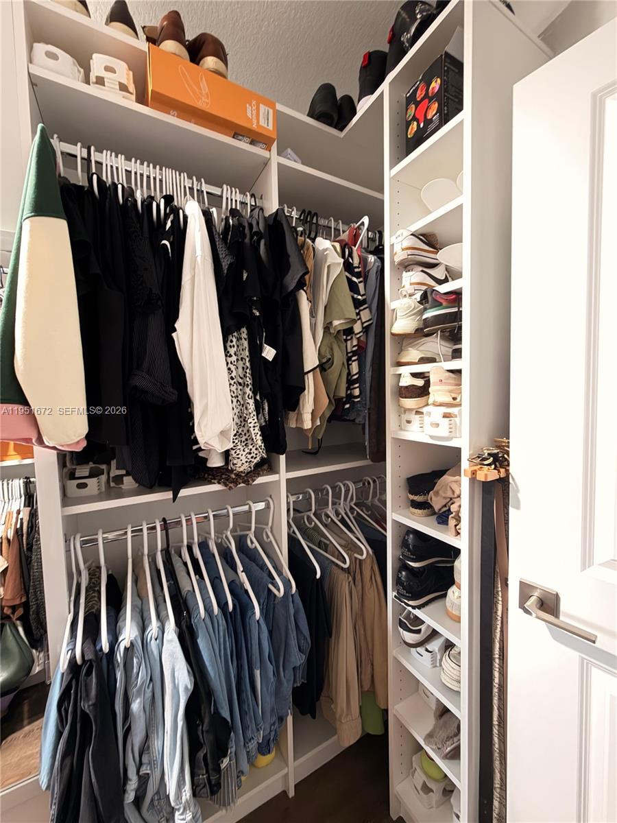 7126 Rockwood Road Jupiter, FL 33458 - Photo 34 of 35 a view of walk in closet with clothes and shoes