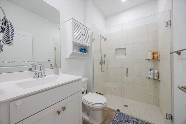 a bathroom with a sink toilet and shower