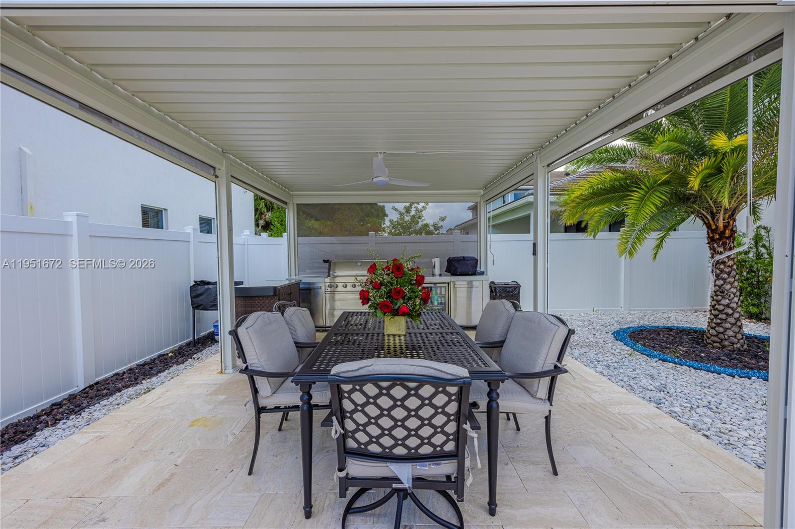 7126 Rockwood Road Jupiter, FL 33458 - Photo 10 of 35 a view of an outdoor dining space with a table and chairs