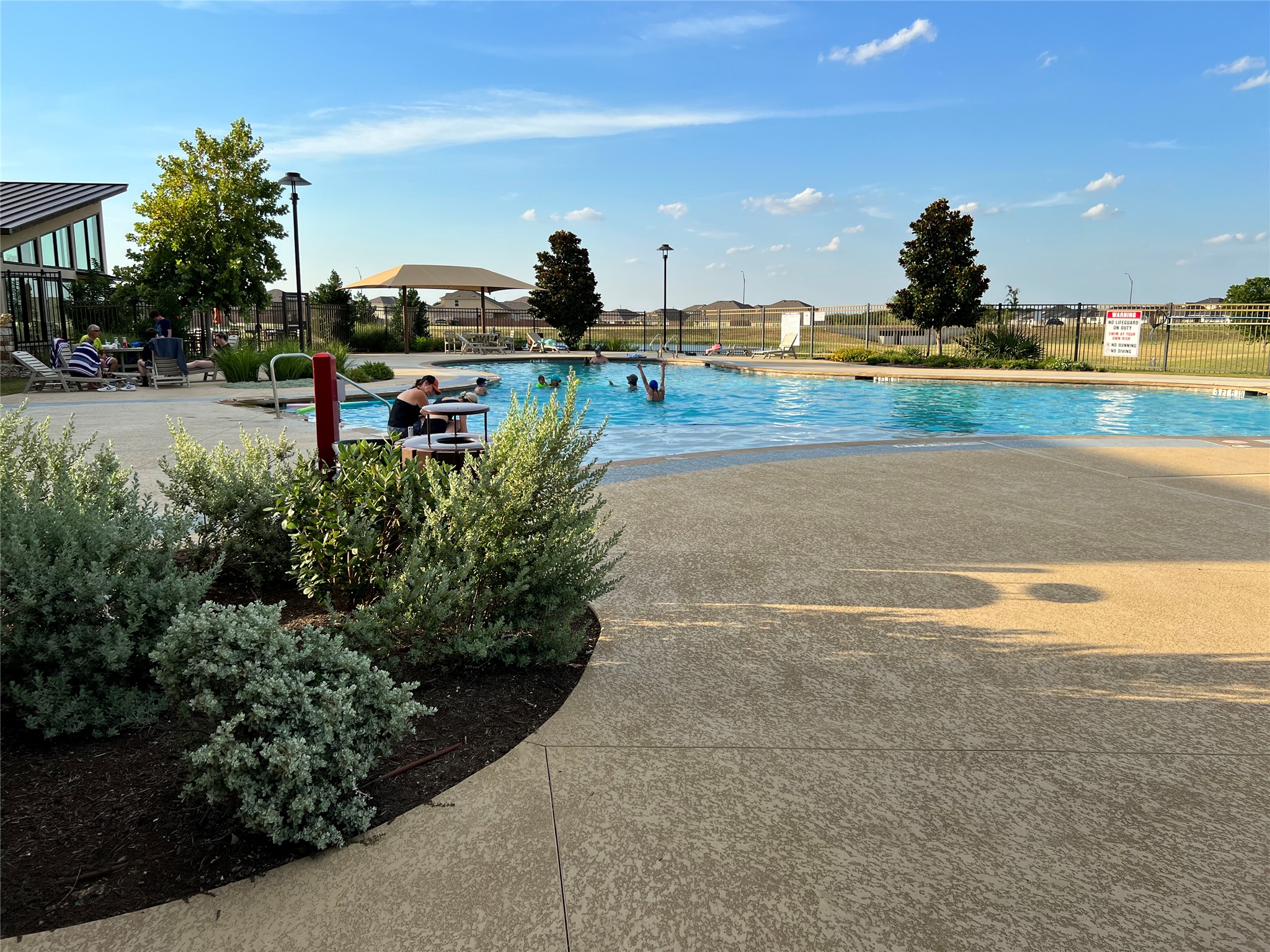 140 Pentro Path Georgetown, TX 78626 - Photo 29 of 37 An inviting outdoor community pool offers relaxation and recreation under a clear sky.