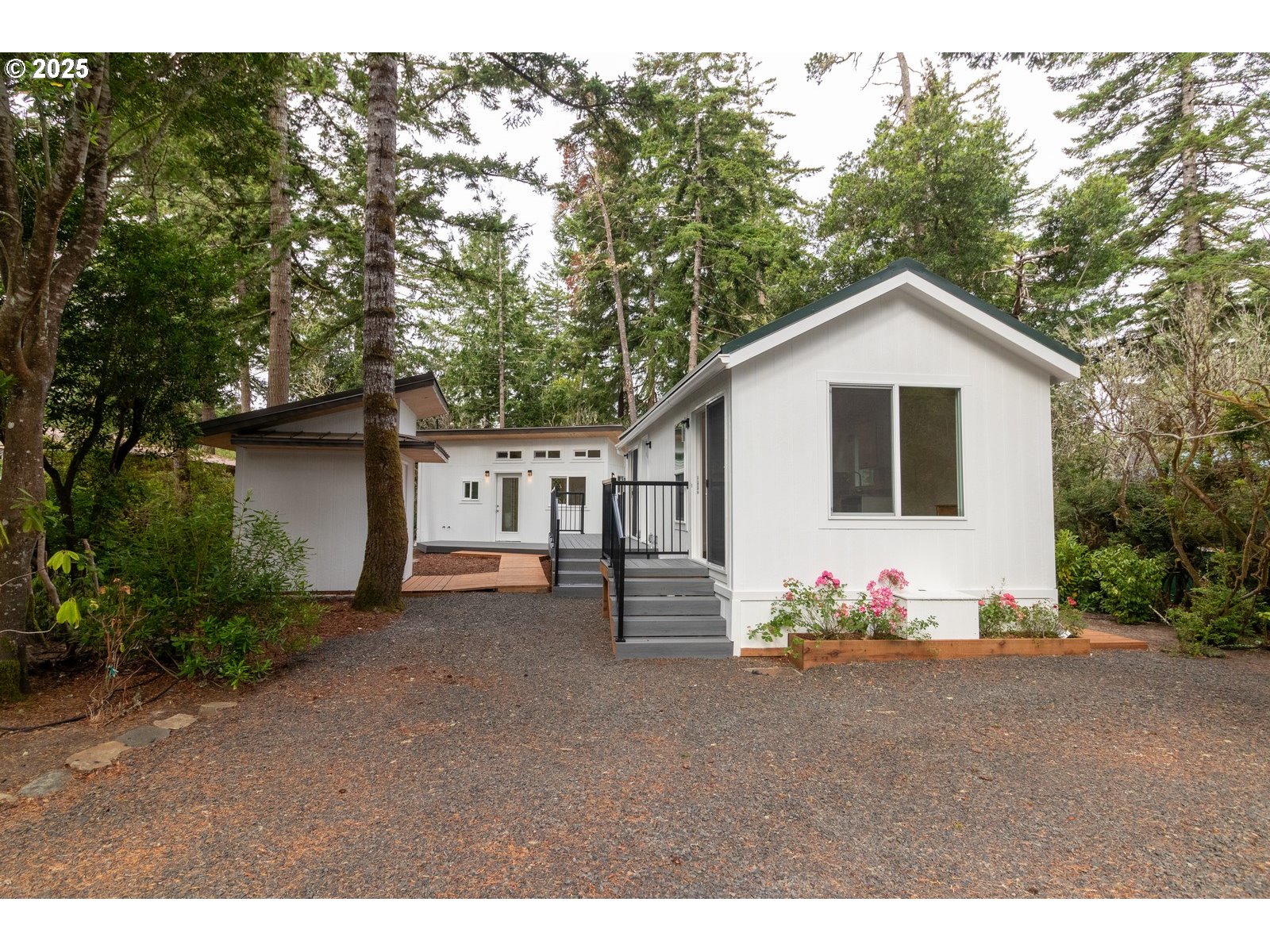 a front view of a house with a tree