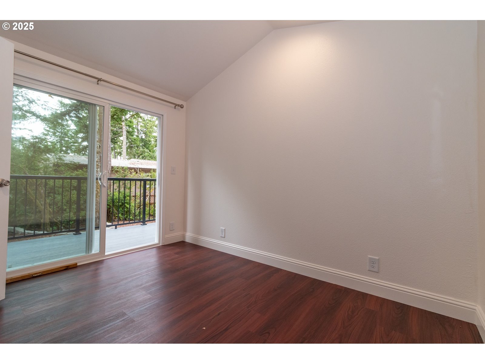 231 Horseshoe Bend Florence, OR 97439 - Photo 12 of 26 a view of an empty room with wooden floor and a window
