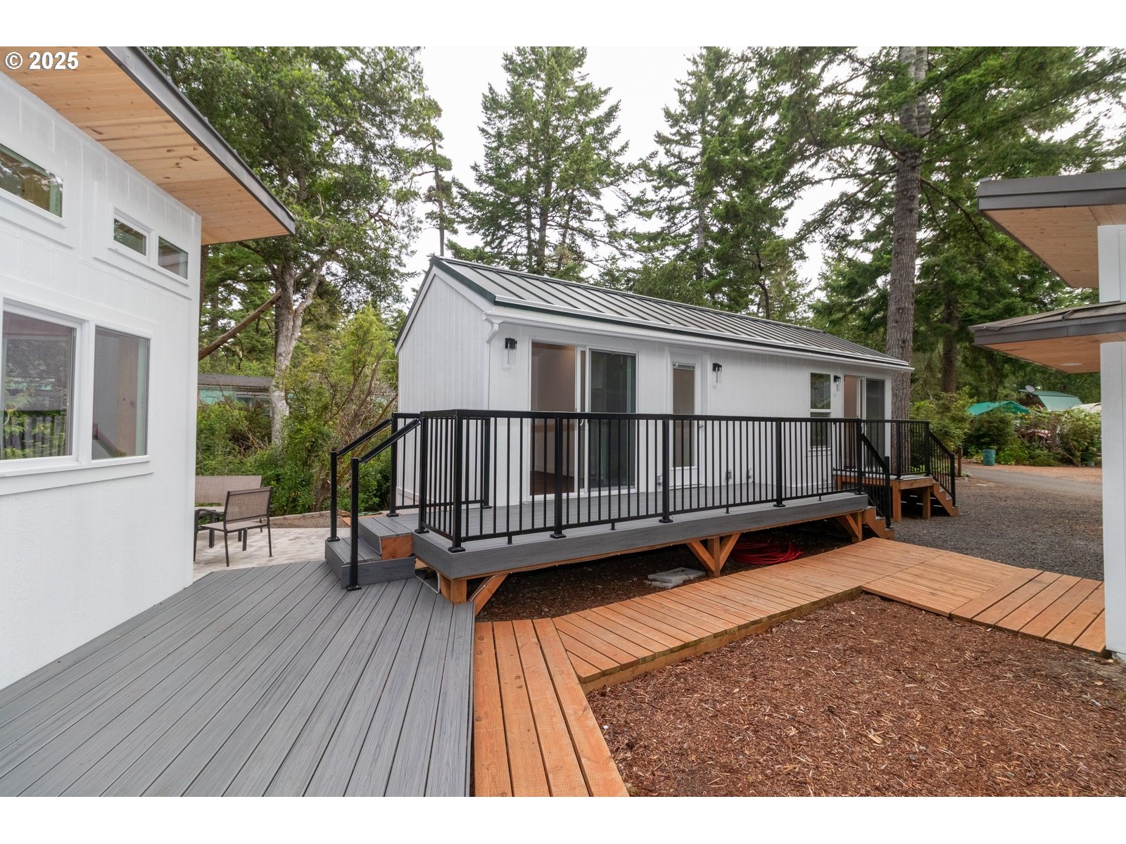 231 Horseshoe Bend Florence, OR 97439 - Photo 14 of 26 a view of a house with a wooden deck and a trees