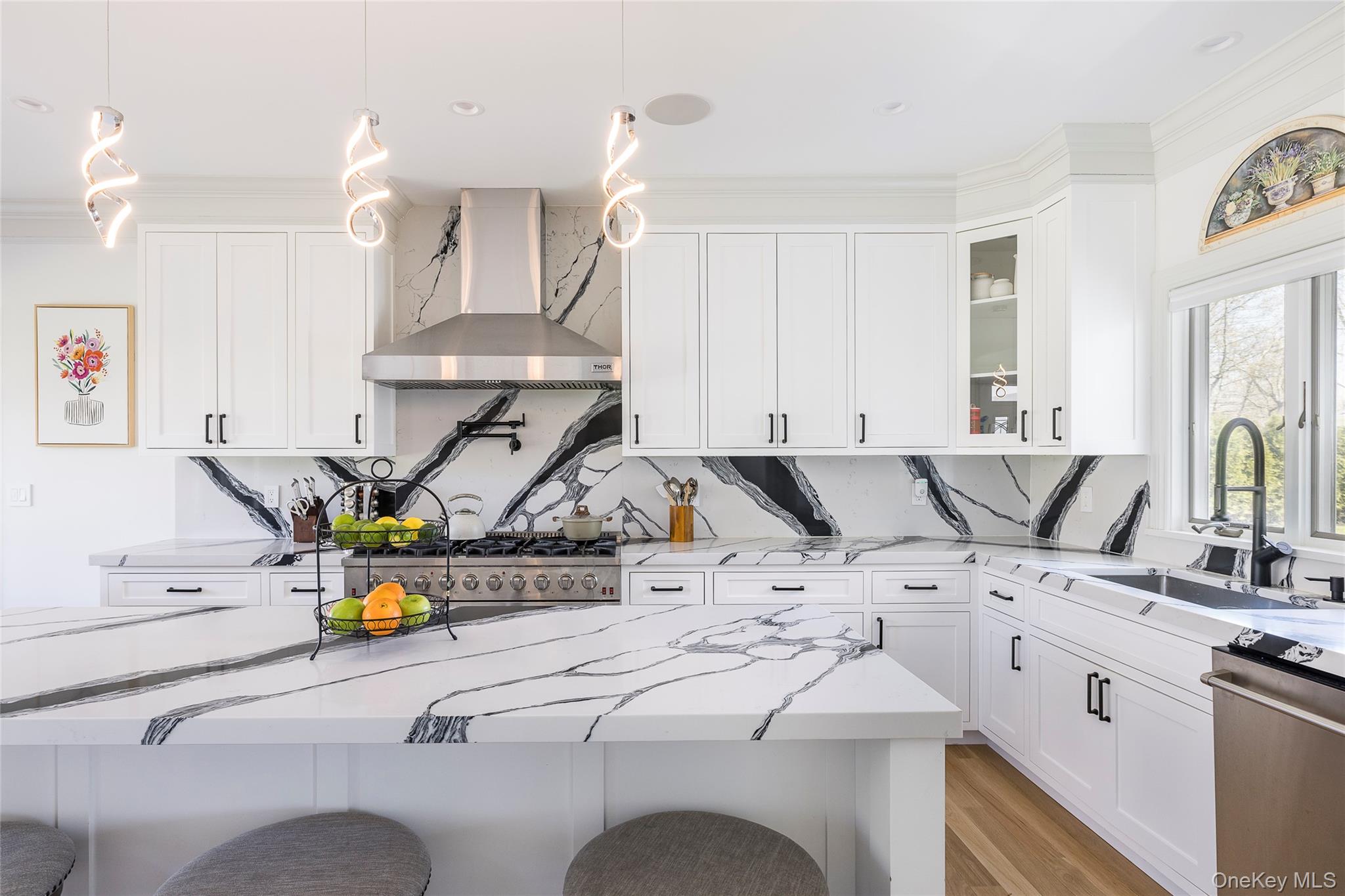 9 Jennifers Path Quiogue, NY 11978 - Photo 7 of 29 Kitchen featuring a sink, a breakfast bar, backsplash, and wall chimney range hood