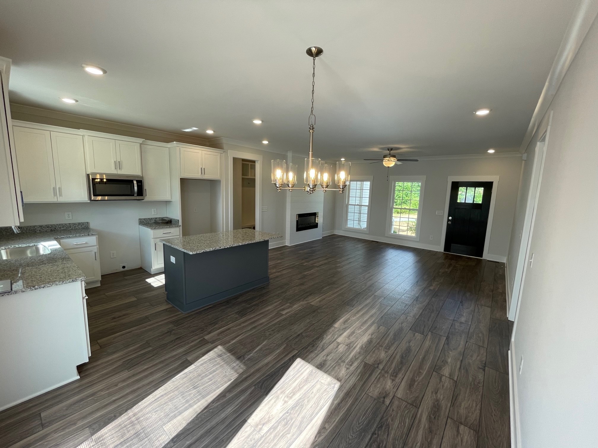 93 Hoodoo Road Beechgrove, TN 37018 - Photo 2 of 4 a view of a kitchen with kitchen island granite countertop wooden floors and a fireplace