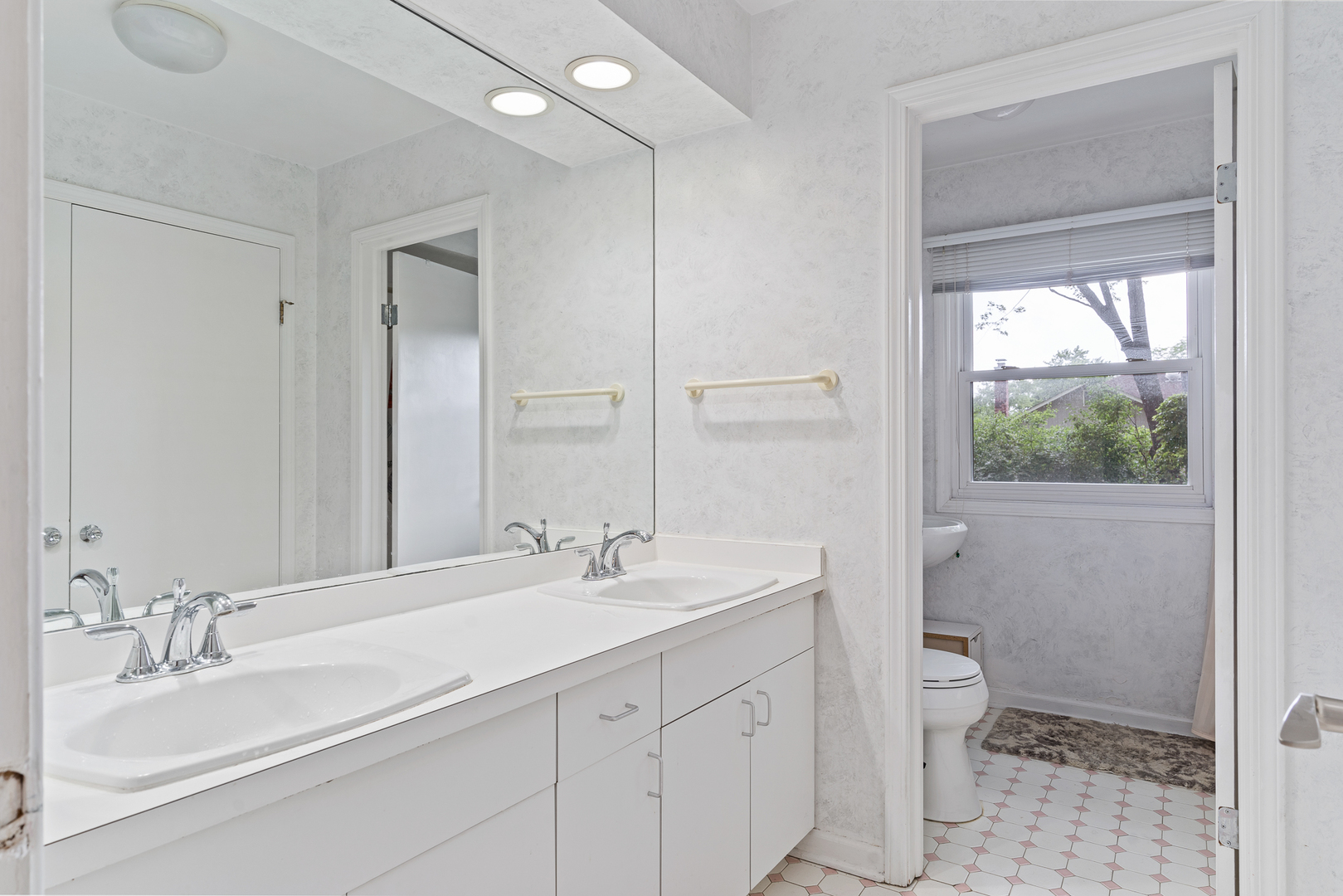 958 Suffield Terrace Northbrook, IL 60062 - Photo 25 of 39 a bathroom with a double vanity sink toilet and a mirror