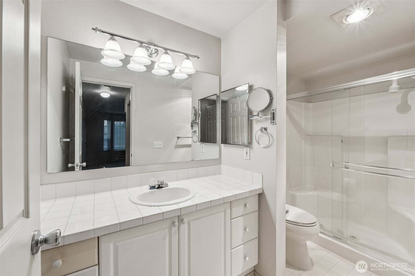 12505 4th Avenue West, Unit 2040 Everett, WA 98204 - Photo 11 of 22 a bathroom with a sink a toilet and a large mirror