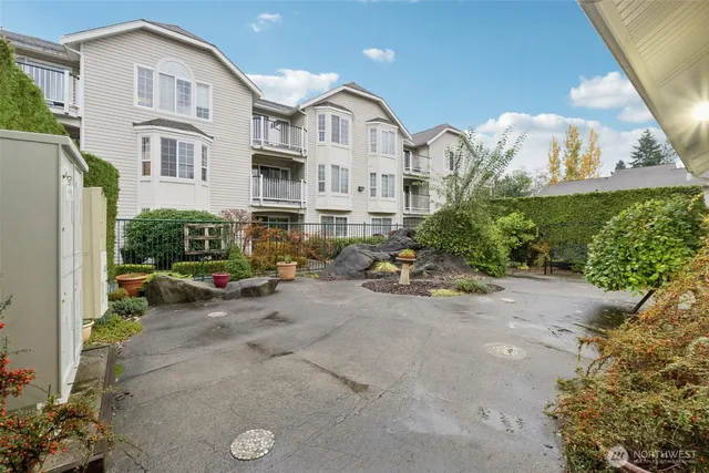 a view of a blue house with a yard and plants