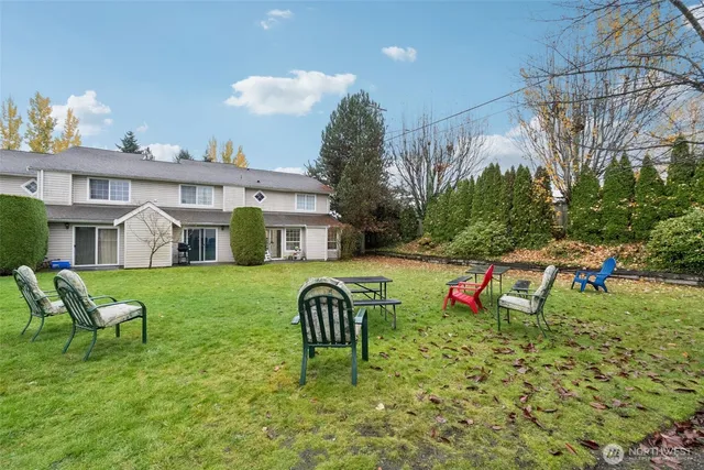 a view of a house with backyard and sitting area