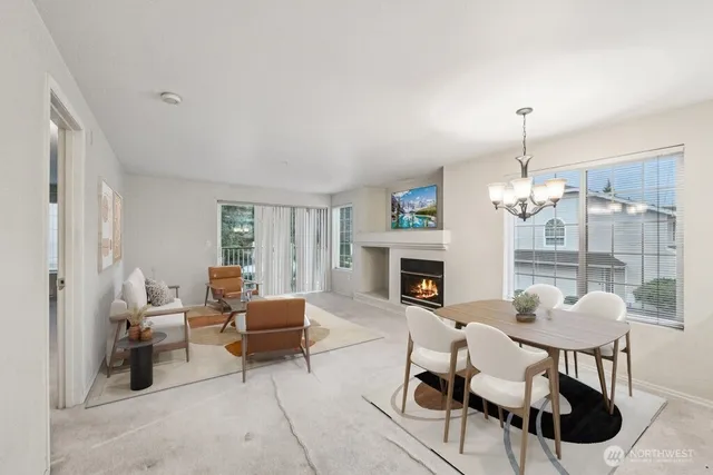 a living room with furniture a fireplace and a chandelier