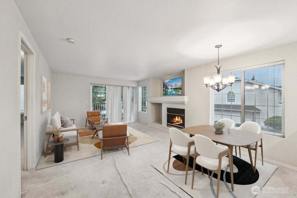 12505 4th Avenue West, Unit 2040 Everett, WA 98204 - Photo 3 of 22 a living room with furniture a fireplace and a chandelier
