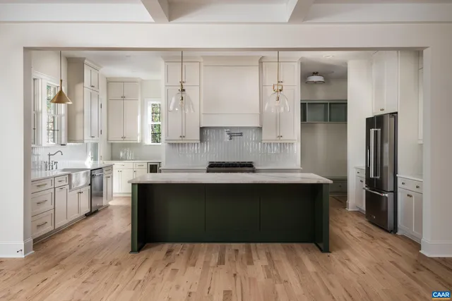 a large kitchen with cabinets wooden floor and stainless steel appliances