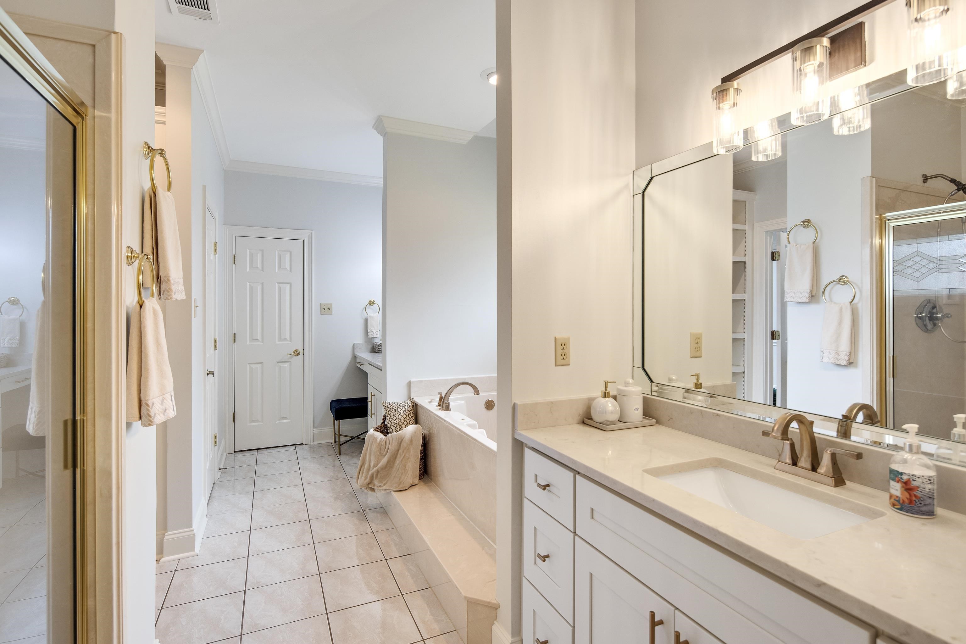 1224 Quinn Road Collierville, TN 38017 - Photo 19 of 33 Bathroom featuring vanity, tile patterned floors, plus walk in shower, and ornamental molding