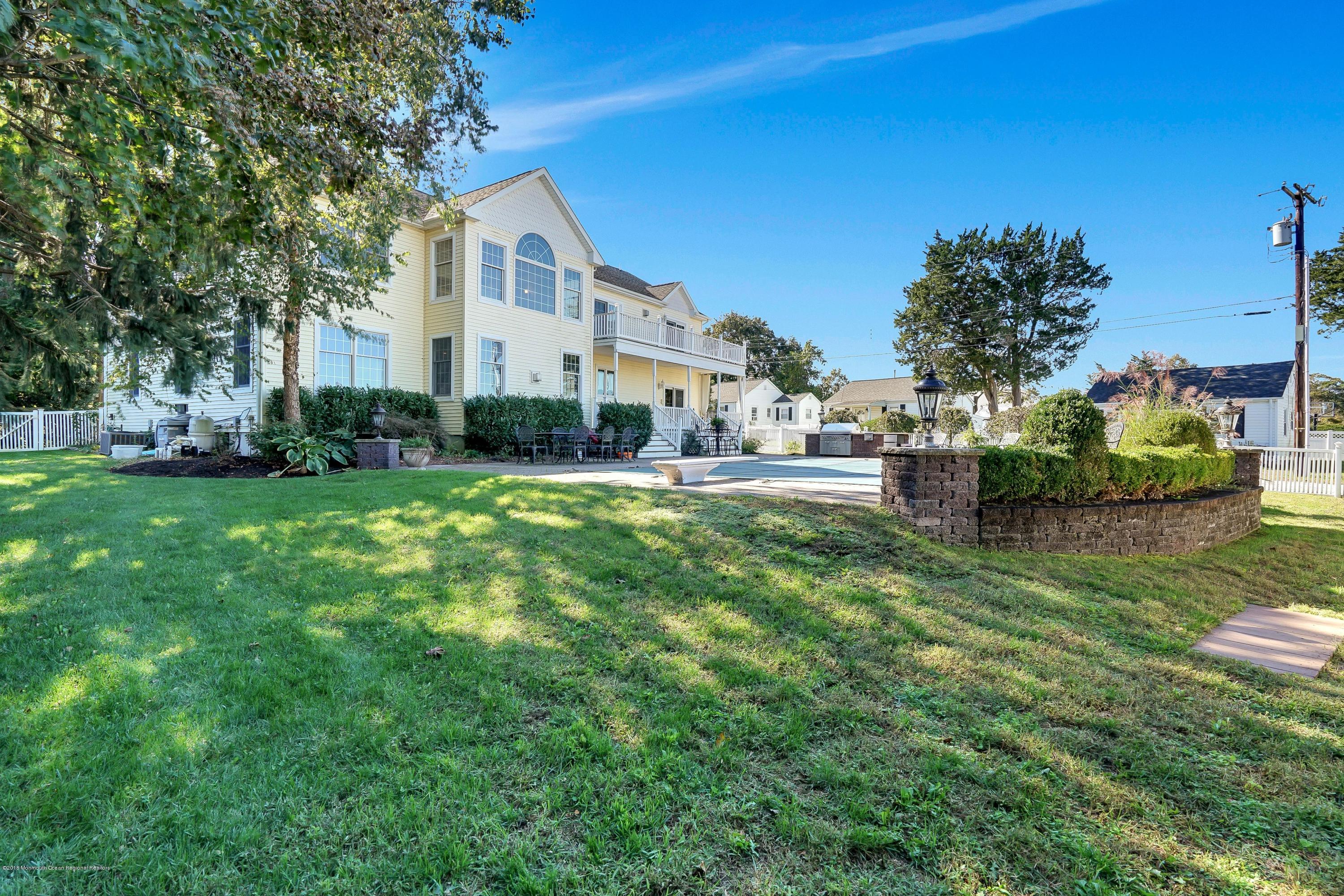 3305A River Road, Unit B Point Pleasant, NJ 08742 - Photo 1 of 56 a front view of a house with a yard and trees