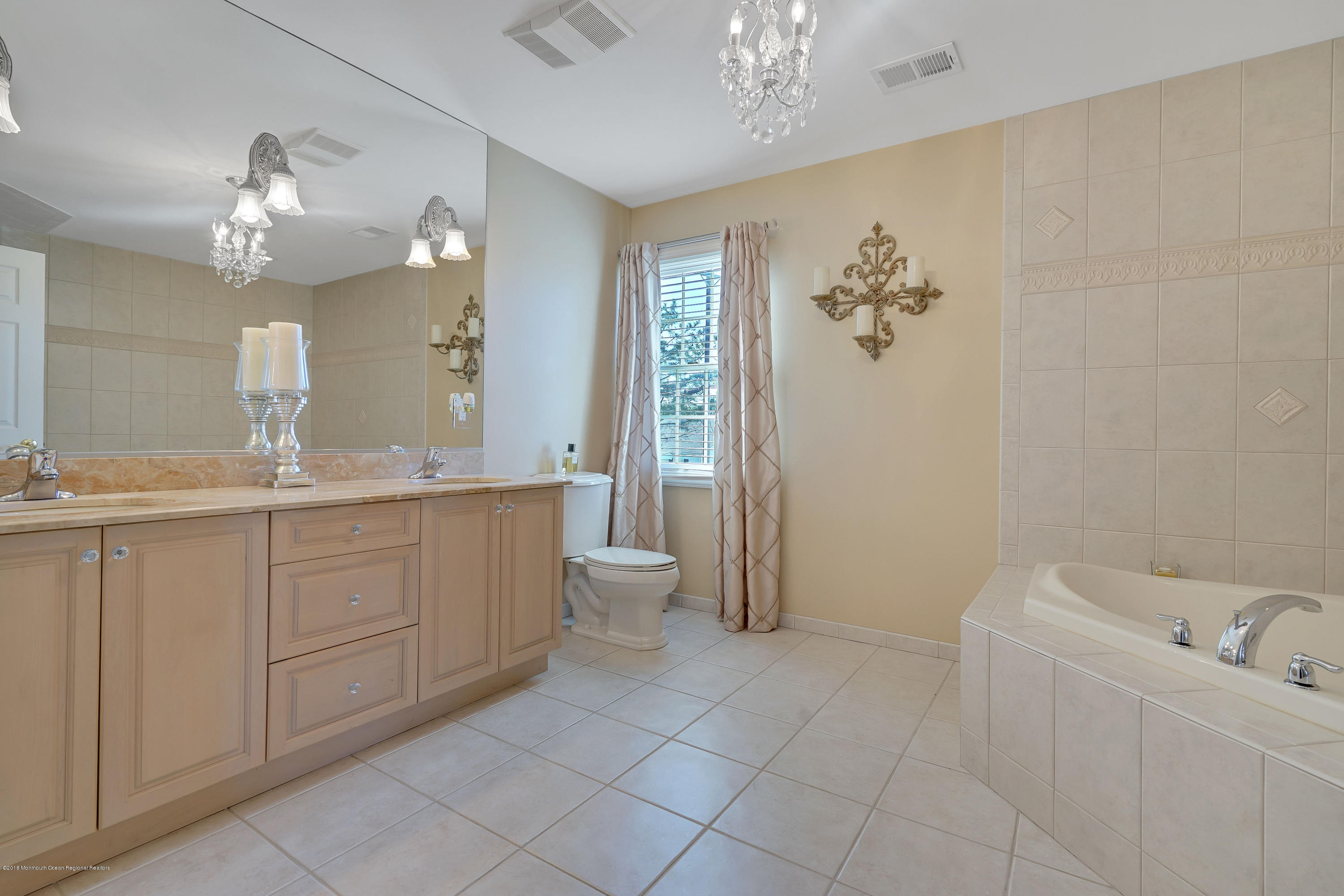 3305A River Road, Unit B Point Pleasant, NJ 08742 - Photo 40 of 56 a bathroom with a double vanity sink a toilet a mirror and shower