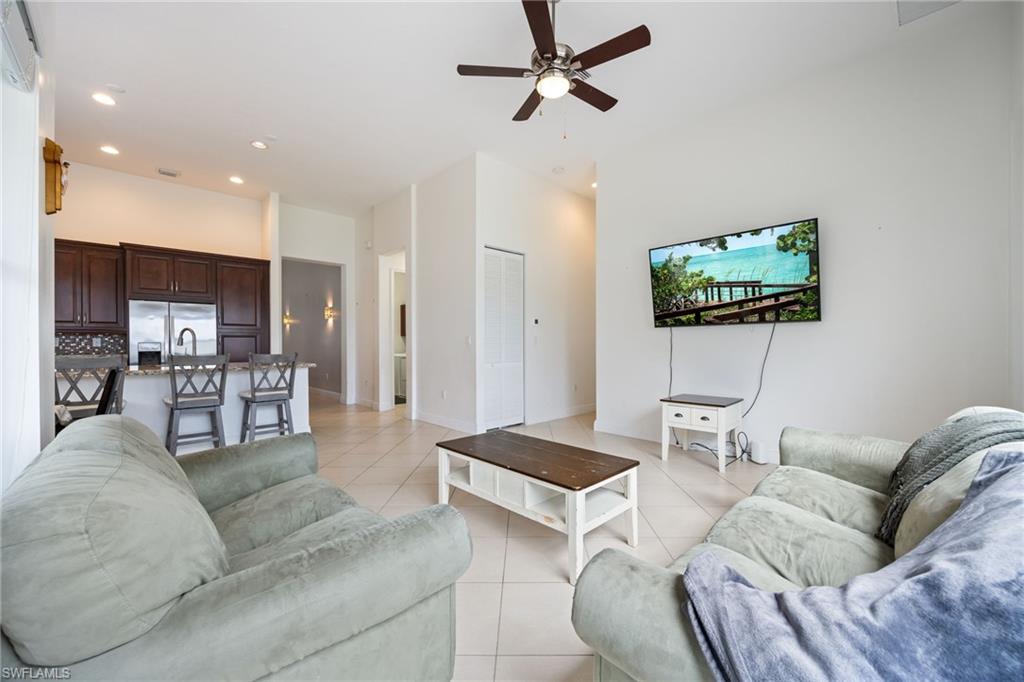 5116 Salerno Street Ave Maria, FL 34142 - Photo 16 of 36 Living area featuring recessed lighting, ceiling fan, light tile patterned floors, and a high ceiling