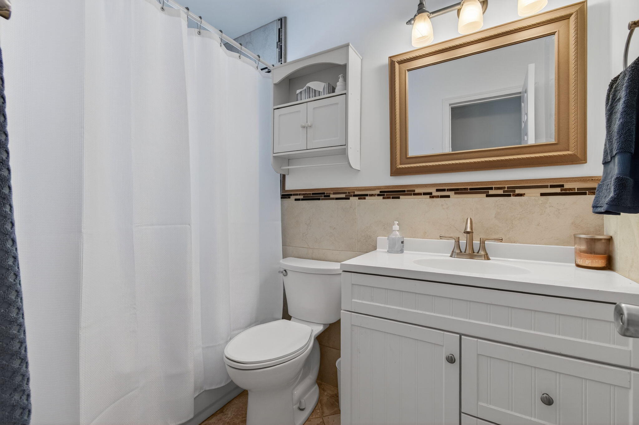 2841 Northeast 8th Terrace Pompano Beach, FL 33064 - Photo 12 of 65 a bathroom with a granite countertop sink vanity mirror and toilet