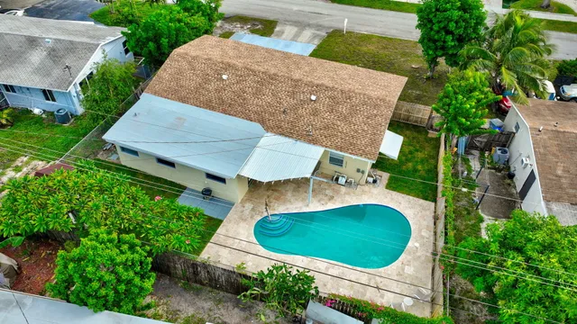a front view of a house with a garden and yard