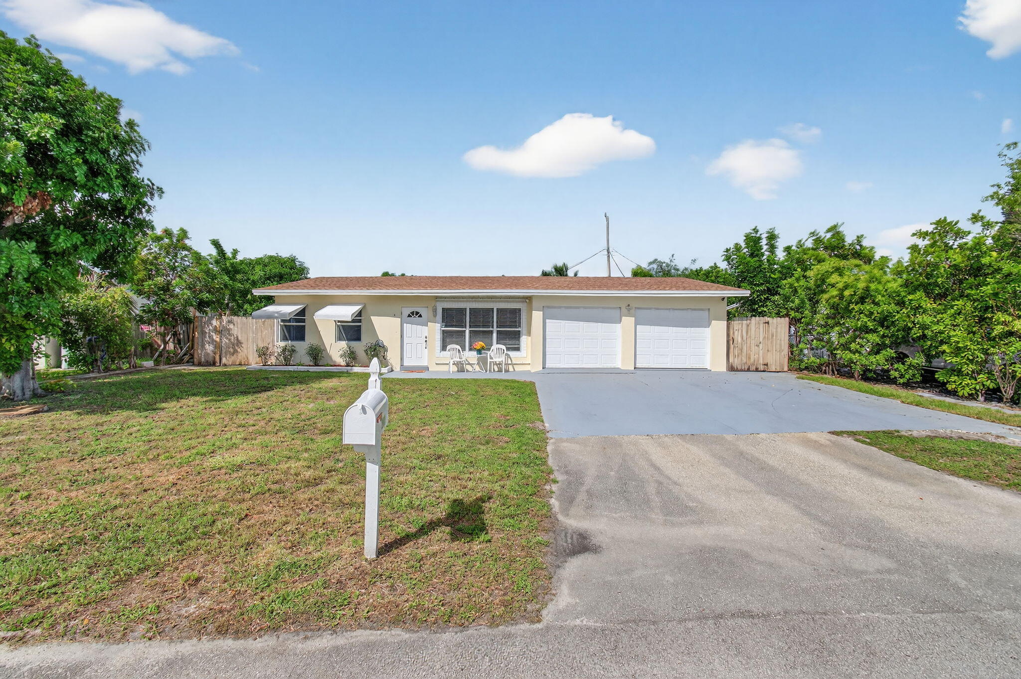 2841 Northeast 8th Terrace Pompano Beach, FL 33064 - Photo 14 of 65 a front view of a house with a yard