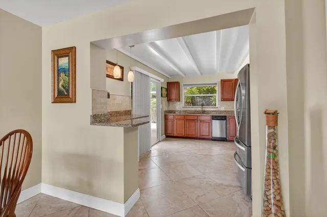a kitchen with stainless steel appliances granite countertop a refrigerator and a sink