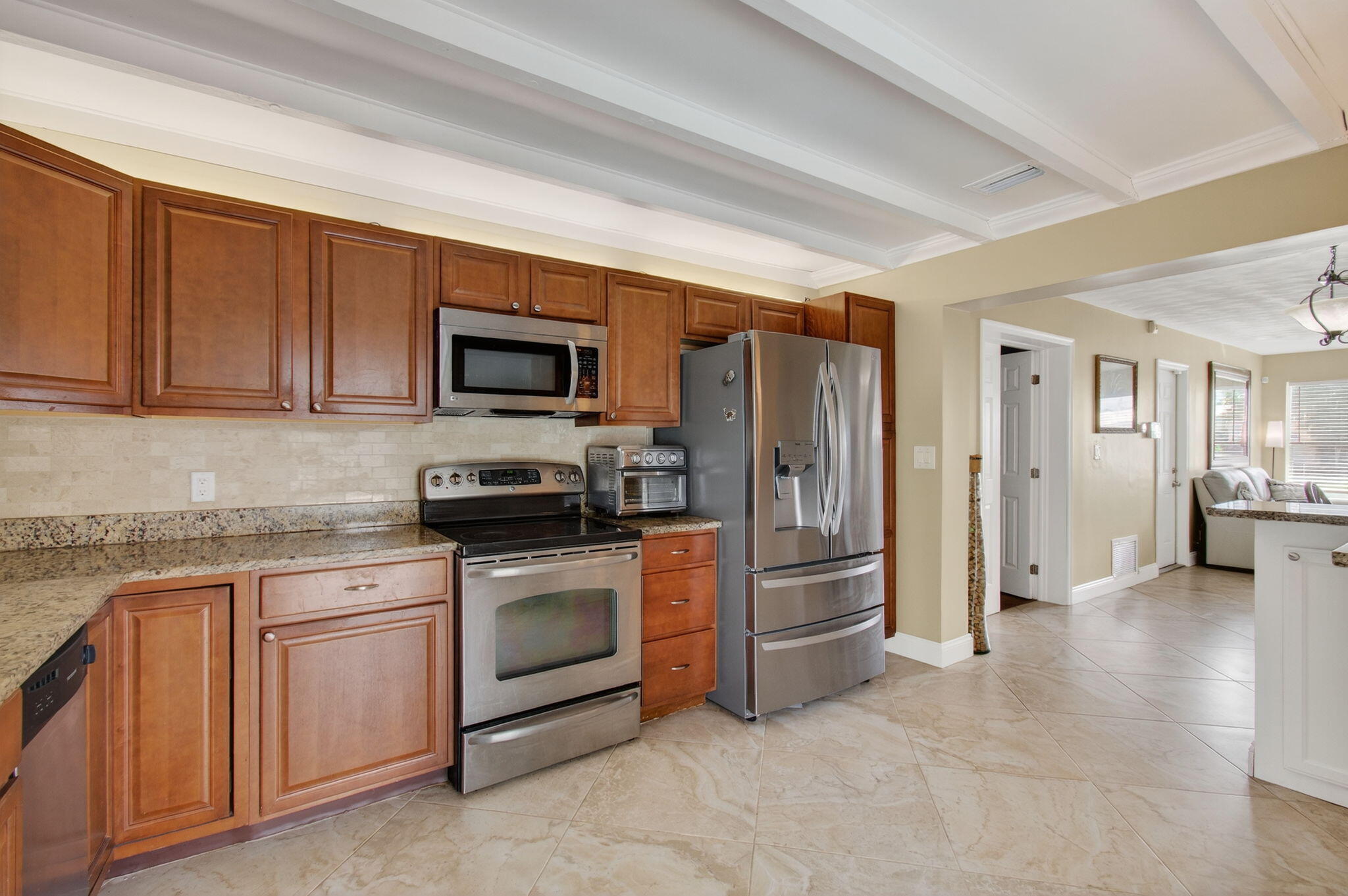 2841 Northeast 8th Terrace Pompano Beach, FL 33064 - Photo 28 of 65 a kitchen with stainless steel appliances granite countertop a refrigerator stove and sink