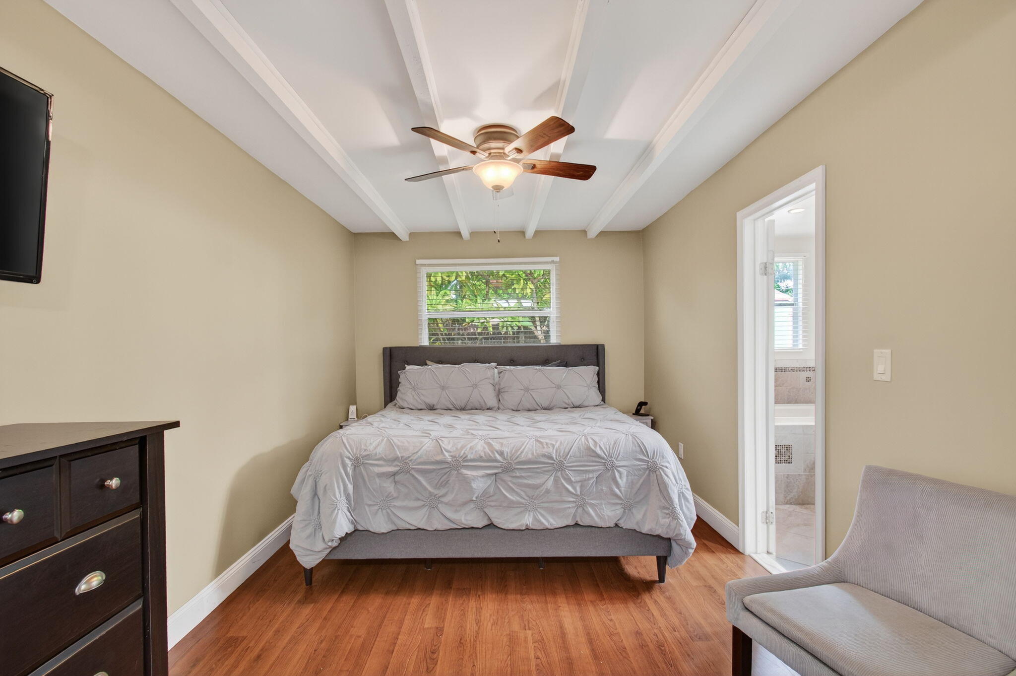 2841 Northeast 8th Terrace Pompano Beach, FL 33064 - Photo 32 of 65 a bedroom with a bed and a chandelier