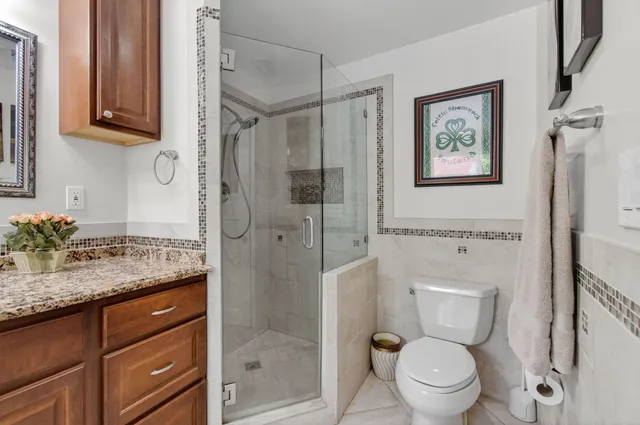 a bathroom with a sink toilet and shower
