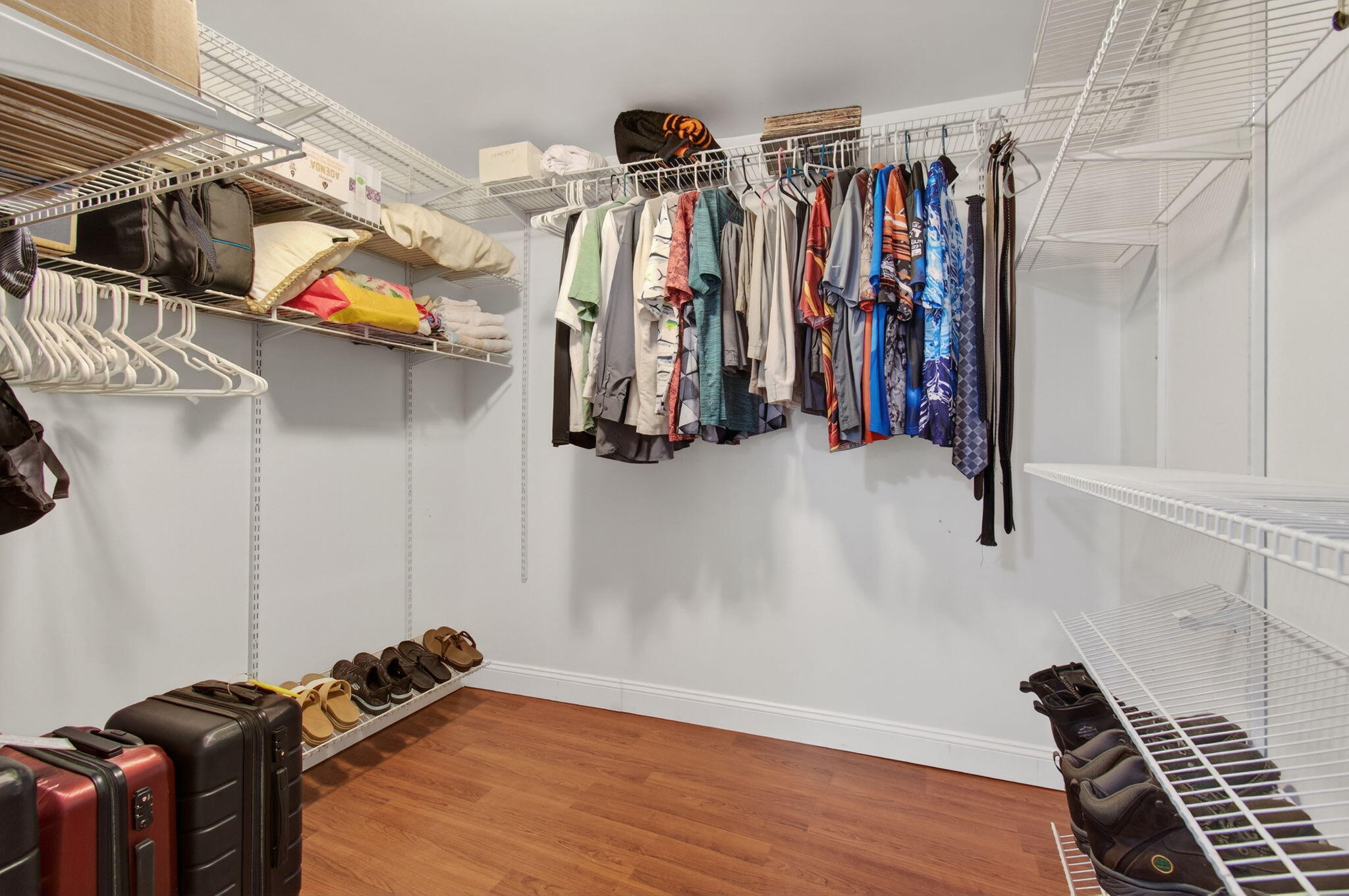 2841 Northeast 8th Terrace Pompano Beach, FL 33064 - Photo 37 of 65 a view of walk in closet with clothes and shoes