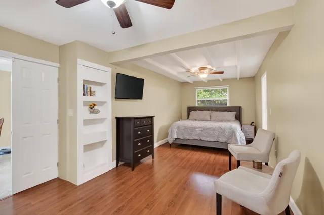 a bedroom with furniture and a flat screen tv