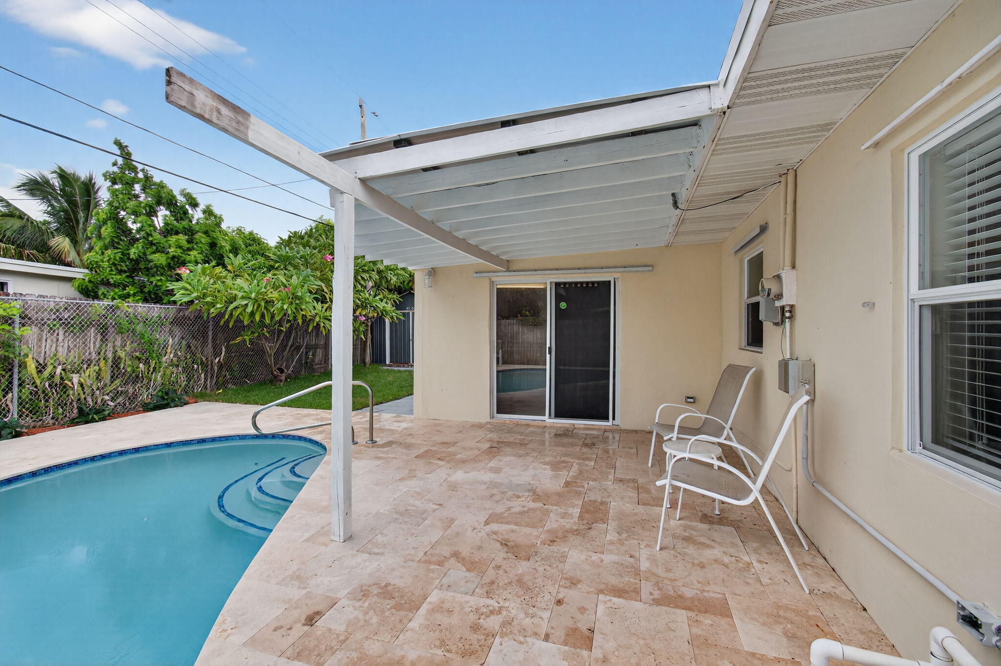 2841 Northeast 8th Terrace Pompano Beach, FL 33064 - Photo 47 of 65 a view of a patio with table and chairs and potted plants