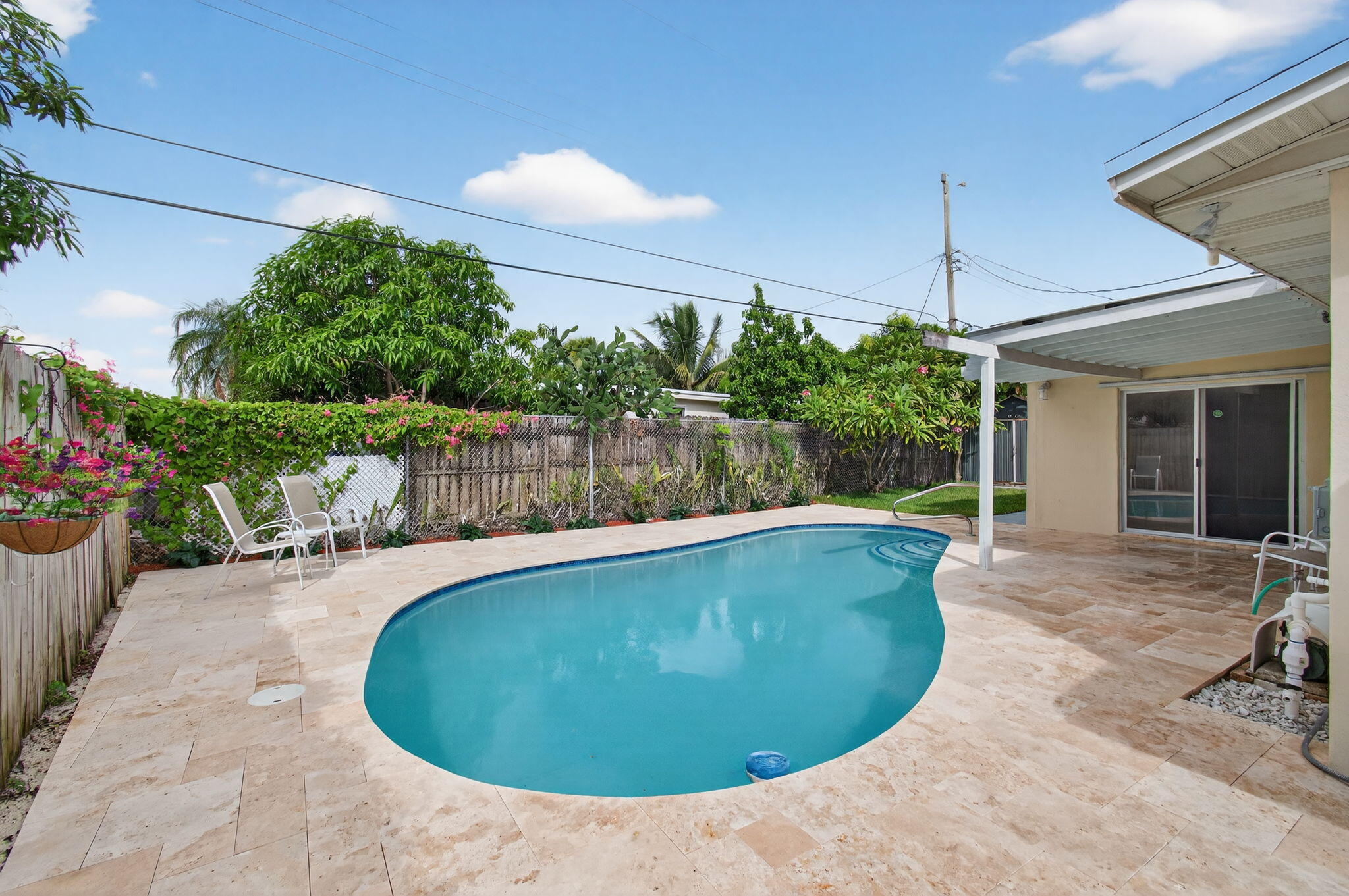 2841 Northeast 8th Terrace Pompano Beach, FL 33064 - Photo 48 of 65 a view of a swimming pool with an outdoor seating