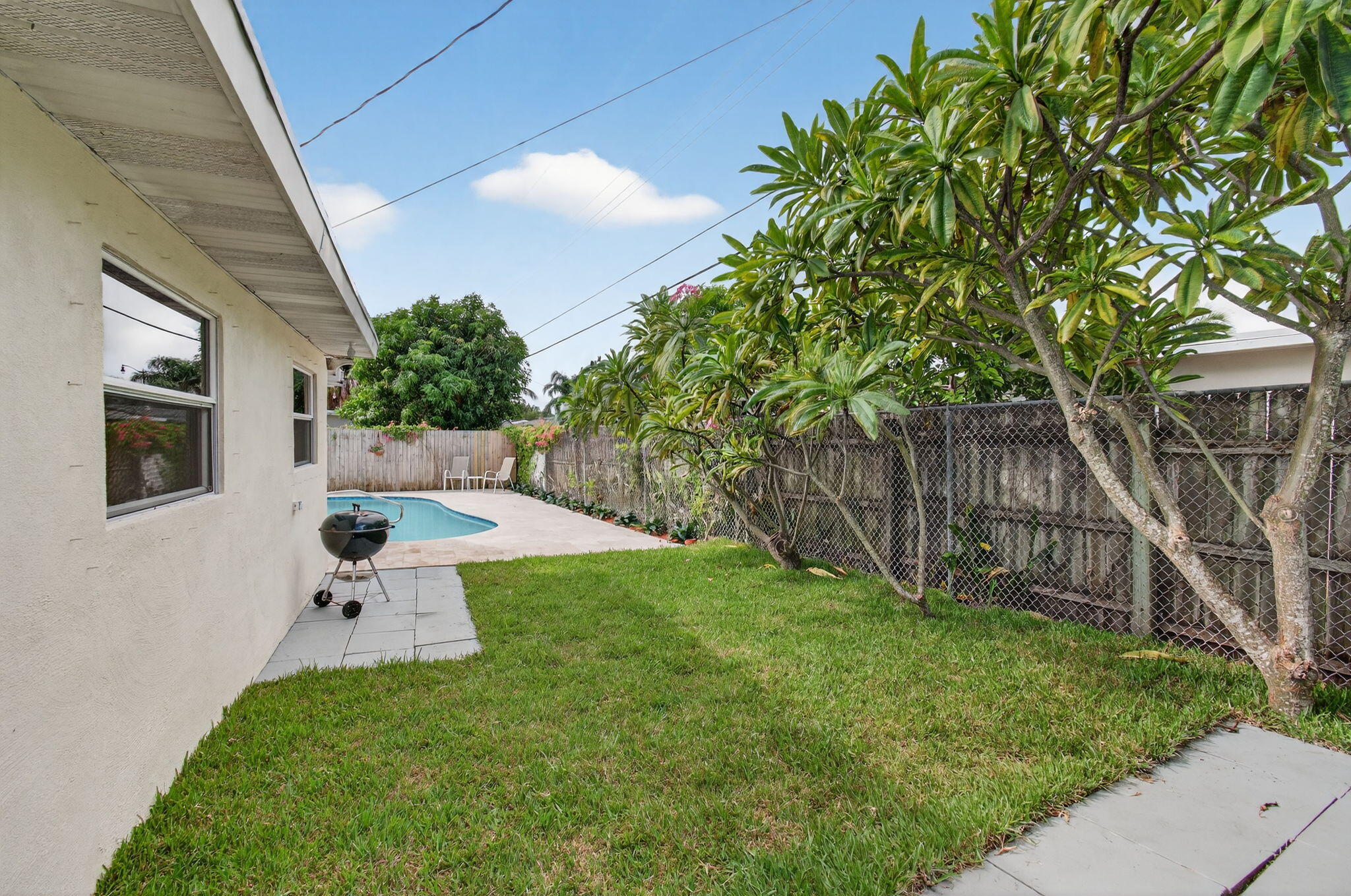 2841 Northeast 8th Terrace Pompano Beach, FL 33064 - Photo 53 of 65 a front view of a house with a yard