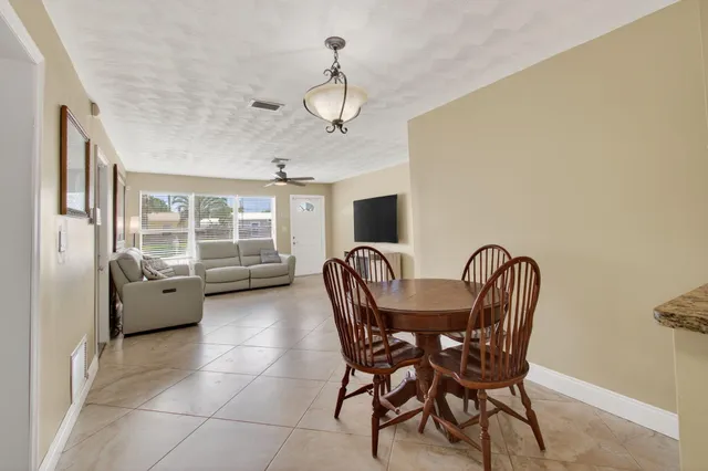 a dining room with furniture and window