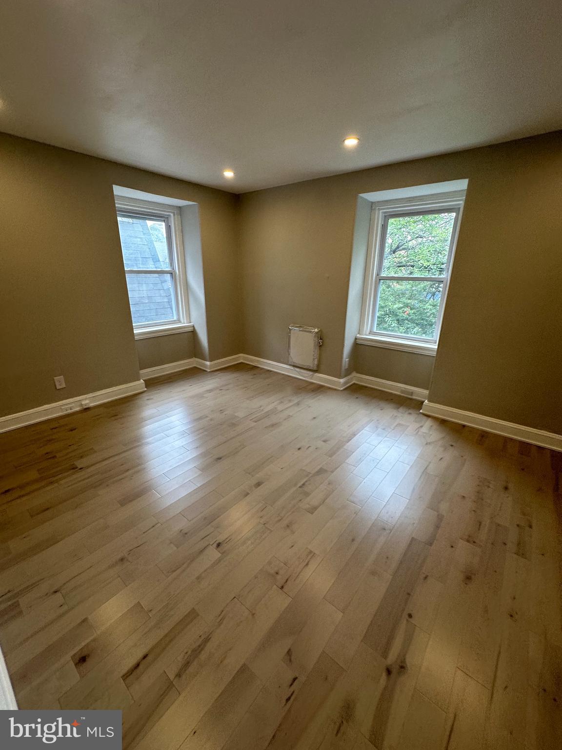 4710 Warrington Avenue, Unit 3 Philadelphia, PA 19143 - Photo 11 of 32 an empty room with wooden floor and windows