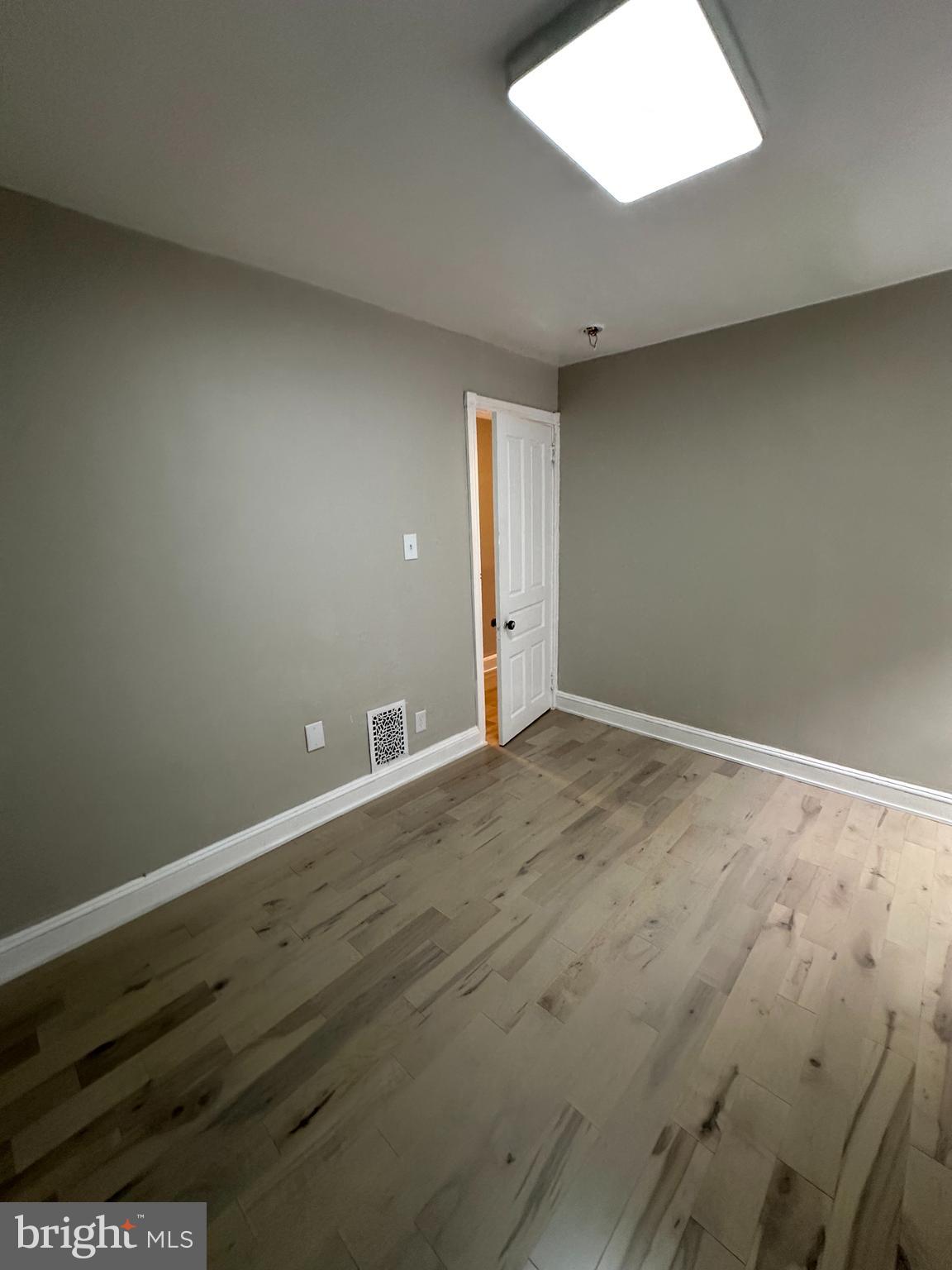 4710 Warrington Avenue, Unit 3 Philadelphia, PA 19143 - Photo 12 of 32 an empty room with wooden floor