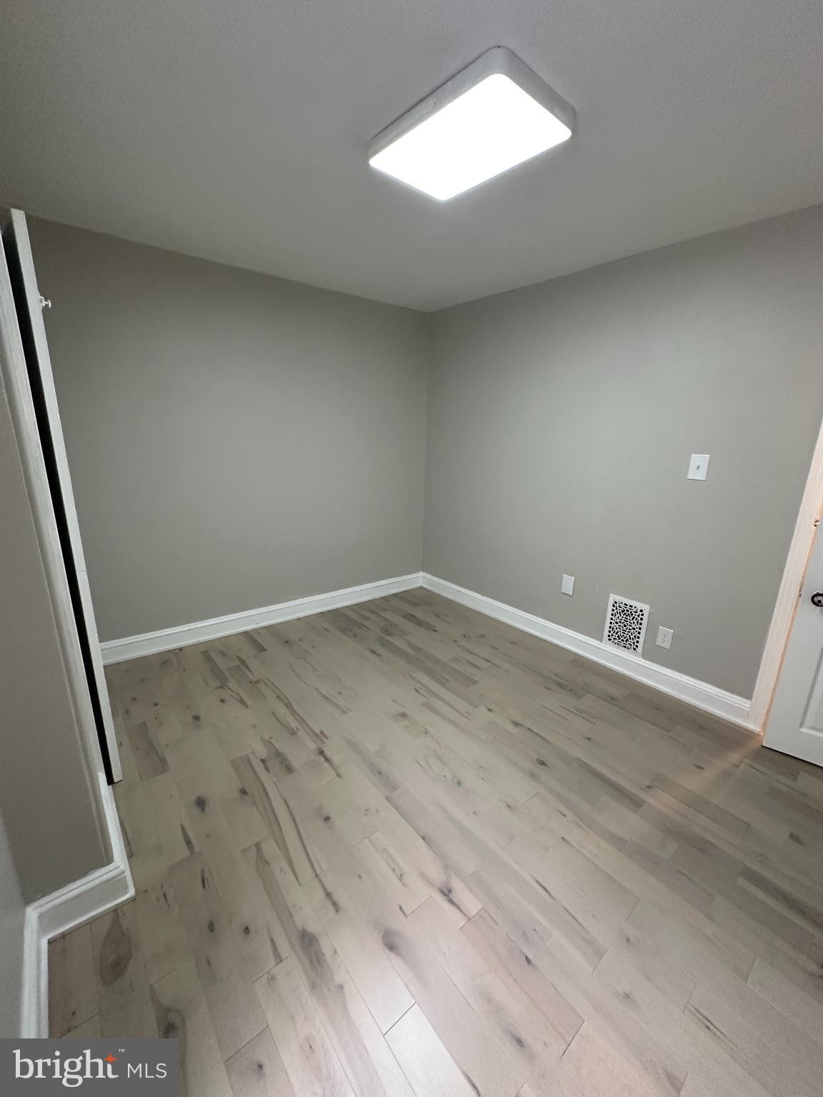 4710 Warrington Avenue, Unit 3 Philadelphia, PA 19143 - Photo 13 of 32 an empty room with wooden floor and windows