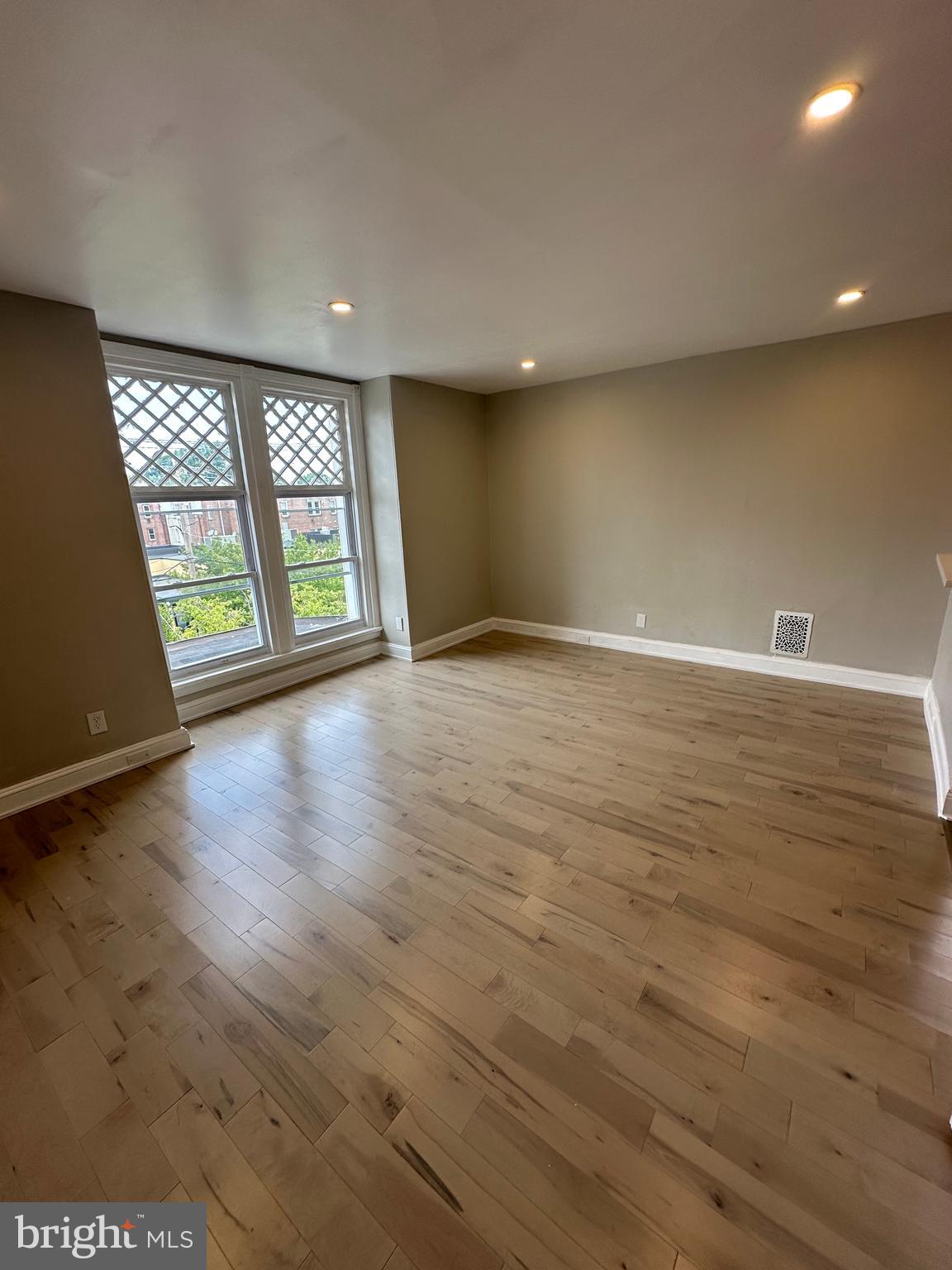 4710 Warrington Avenue, Unit 3 Philadelphia, PA 19143 - Photo 24 of 32 an empty room with wooden floor and windows