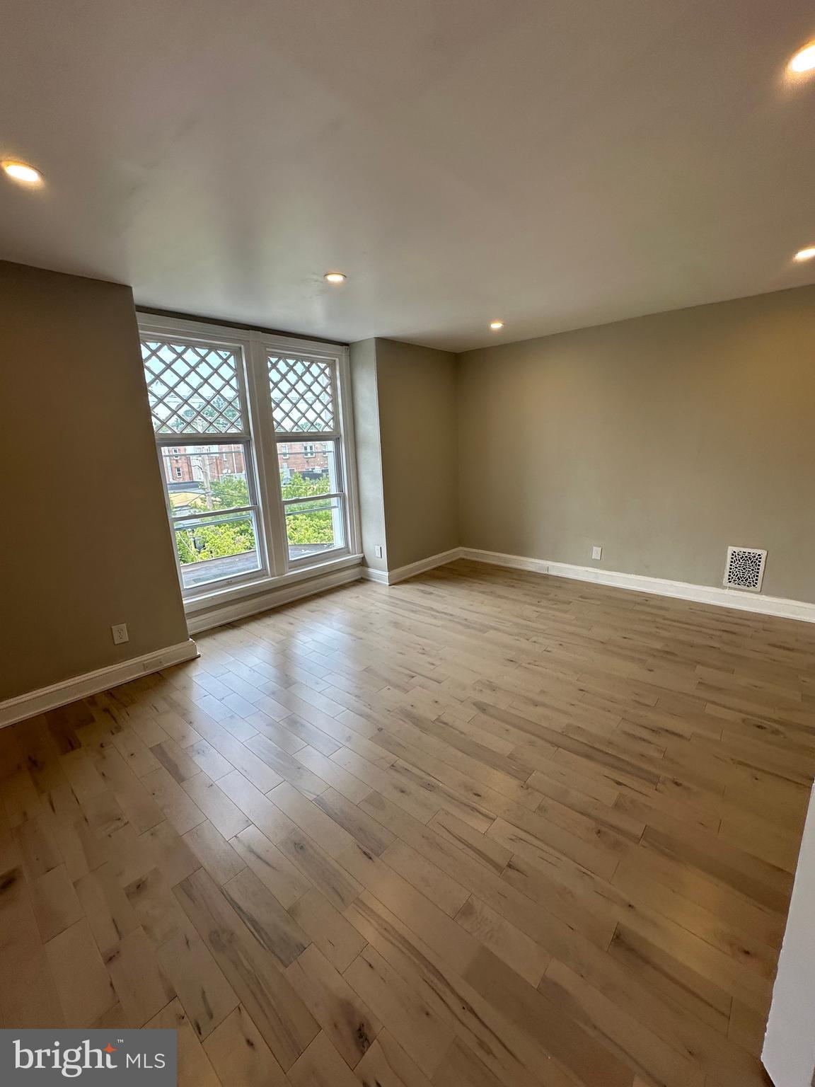 4710 Warrington Avenue, Unit 3 Philadelphia, PA 19143 - Photo 26 of 32 an empty room with wooden floor and windows