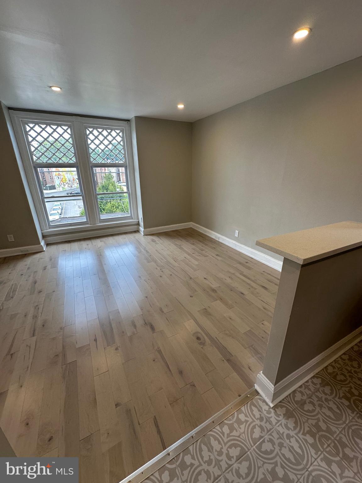 4710 Warrington Avenue, Unit 3 Philadelphia, PA 19143 - Photo 28 of 32 wooden floor in an empty room with a window