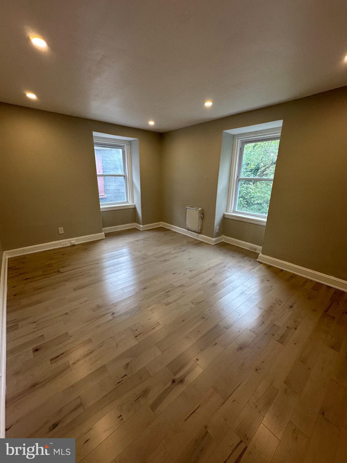 4710 Warrington Avenue, Unit 3 Philadelphia, PA 19143 - Photo 7 of 32 an empty room with wooden floor and windows