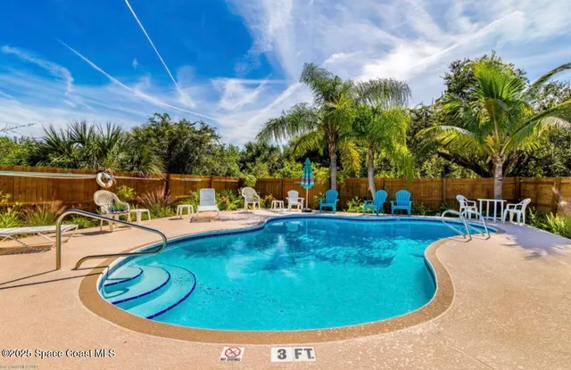 a view of a swimming pool with an outdoor seating