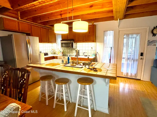 a kitchen with stainless steel appliances granite countertop a sink and wooden floor