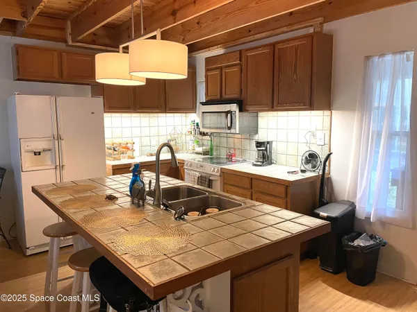 a kitchen with a sink a stove and a wooden cabinets