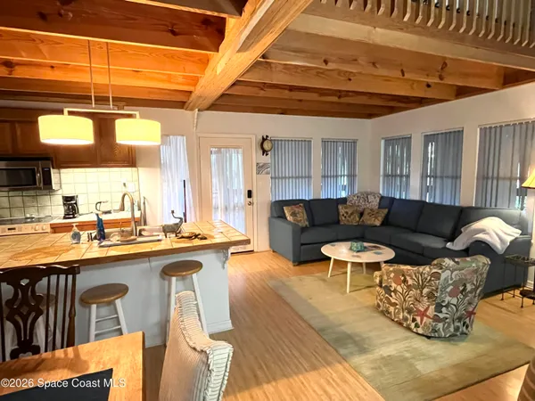 a living room with stainless steel appliances granite countertop lots of counter top space