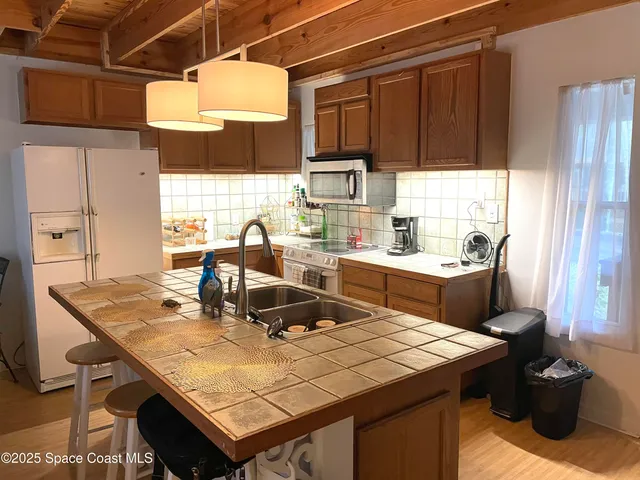 a kitchen with a sink a stove and a wooden cabinets