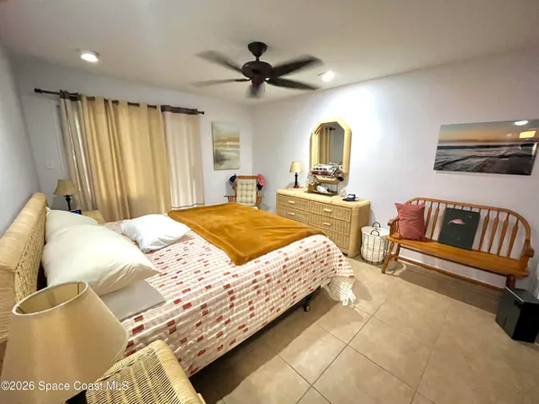 a bedroom with a bed couch and window