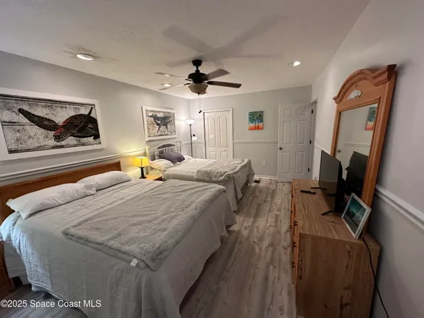 a bed room with bed and a flat screen tv